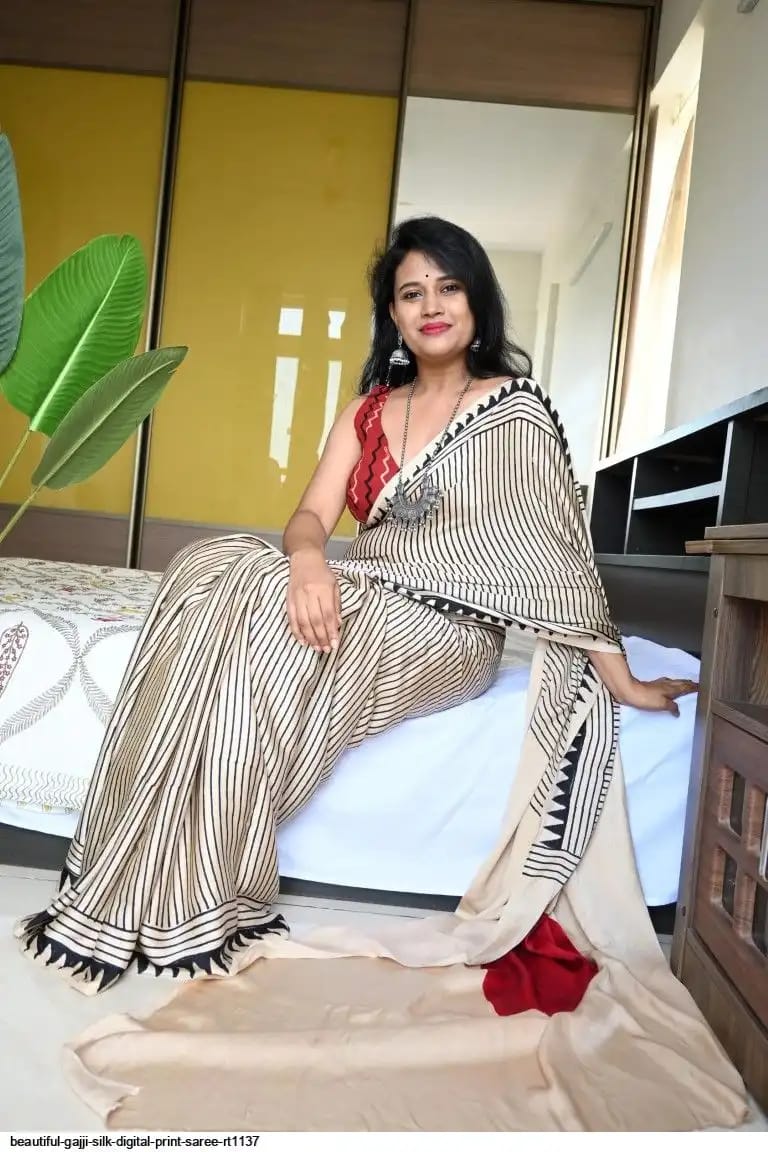 Close-up of red bindi motif on beige Ajrakh saree