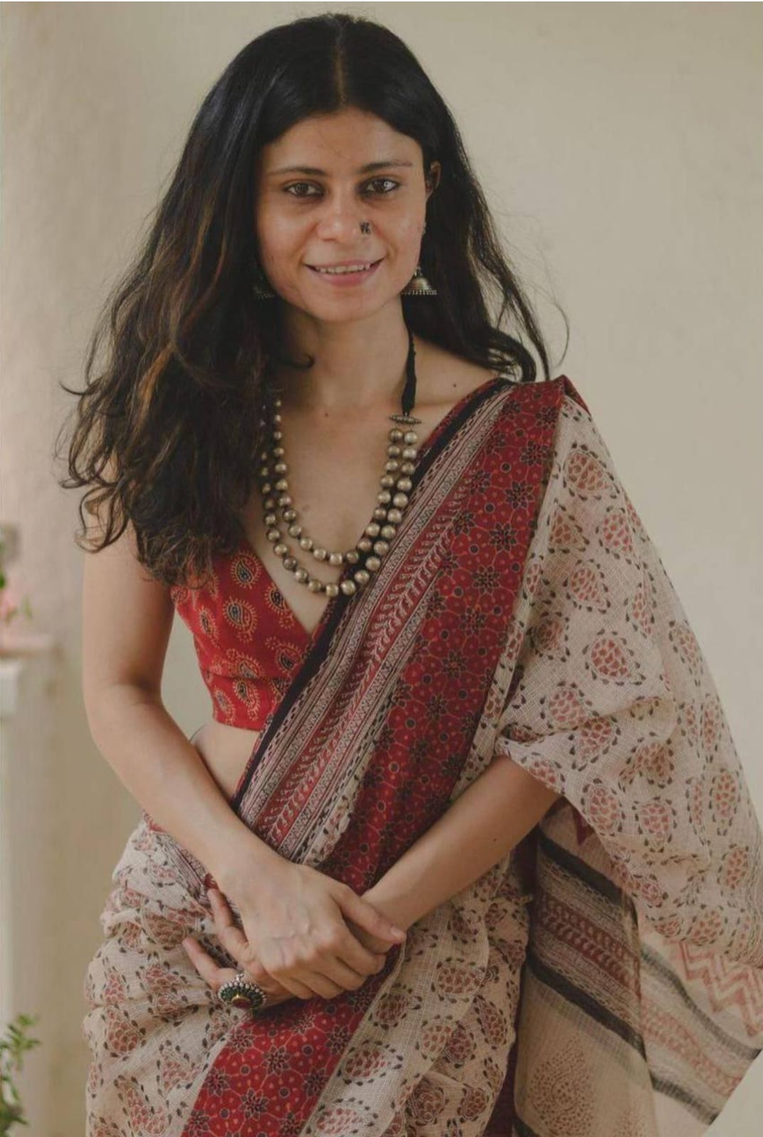 Close-up of the saree's intricate digital floral print on soft beige linen fabric