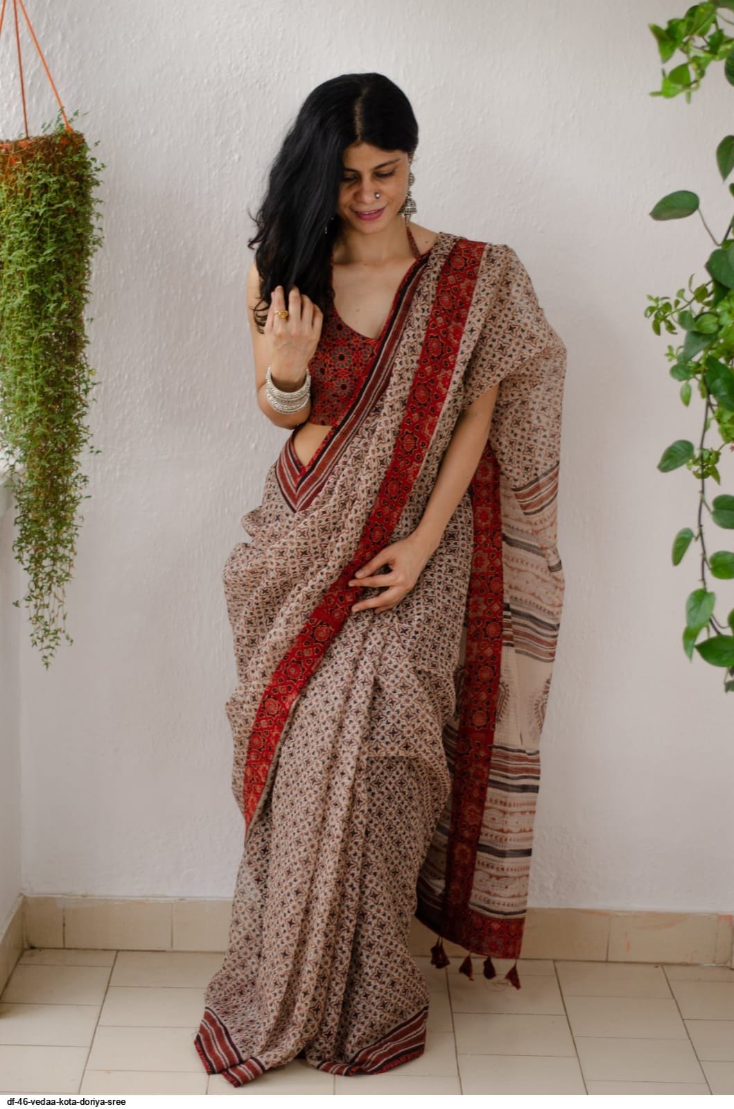 Flat lay of the beige saree with digitally printed blouse piece neatly folded